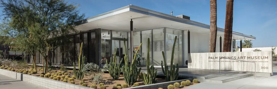 The glass-and-steel Edwards Harris Pavilion entrance behind desert landscaping in Palm Springs.