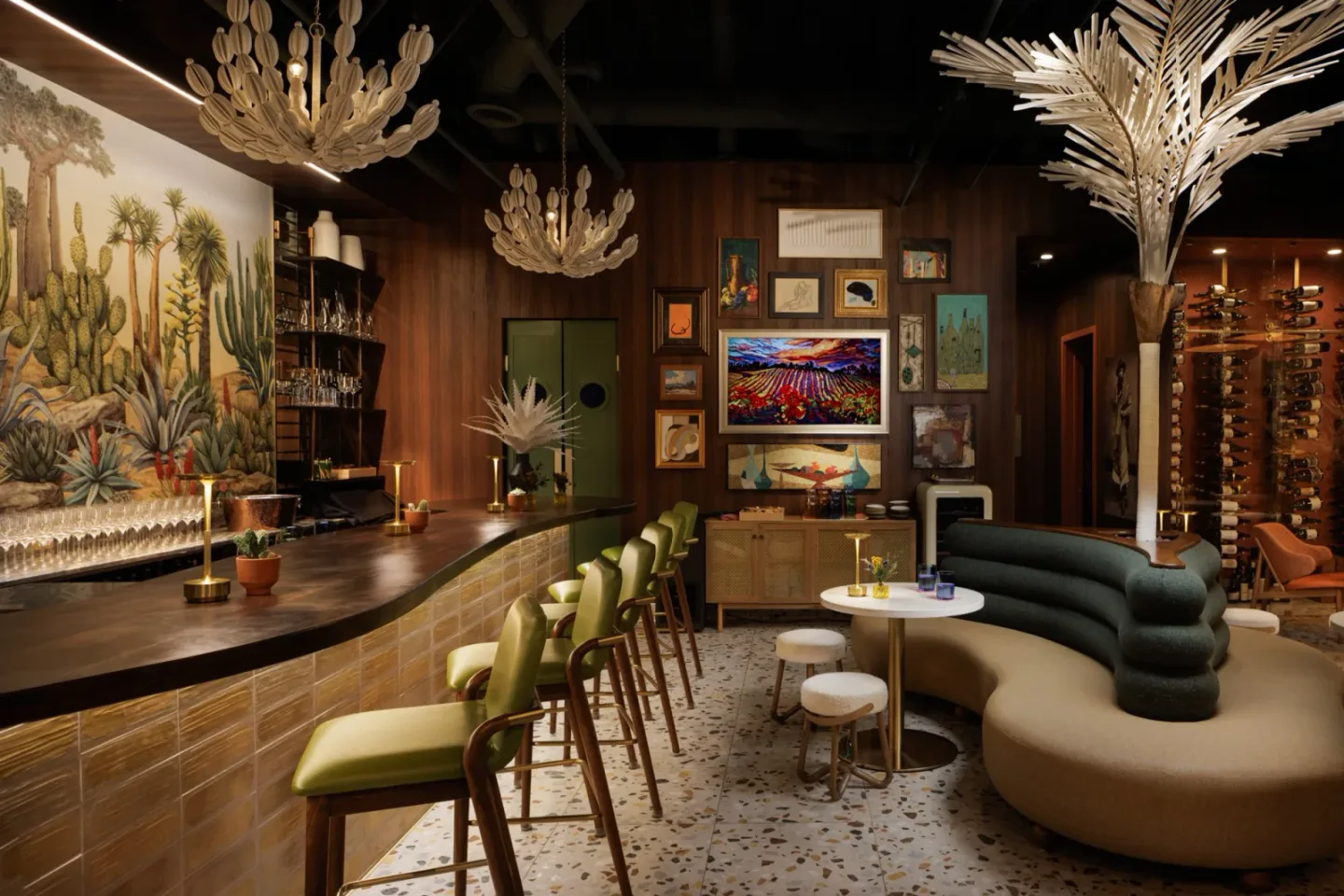 Green barstools and rounded lounge seating inside Canopy Wine Lounge beneath sculptural pendant lights and desert artwork.