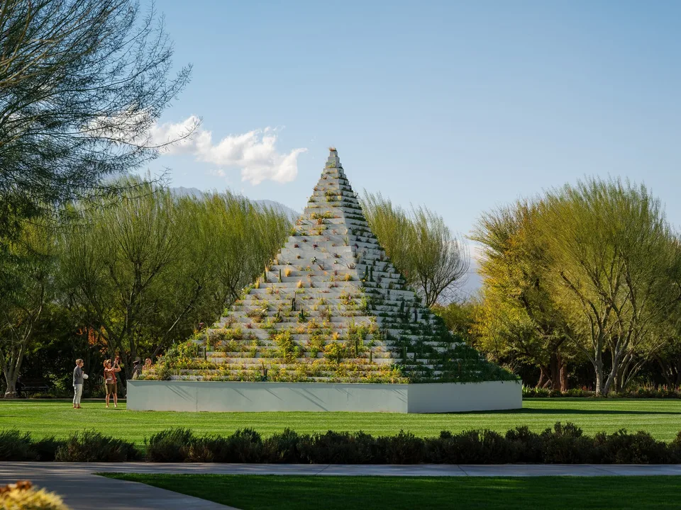 Agnes Denes's planted Living Pyramid rises between desert trees at Sunnylands during Desert X 2025.