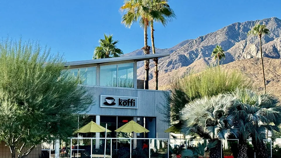 Koffi’s South Palm Springs storefront sits among palms beneath the San Jacinto Mountains.