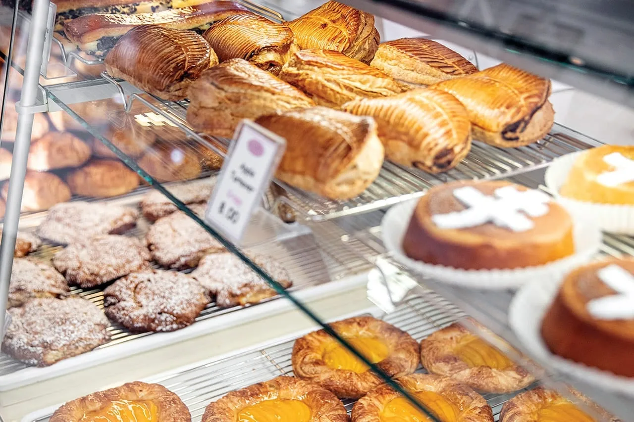 Croissants, pain au chocolat, turnovers, and cakes fill the glass pastry case at Peninsula Pastries.