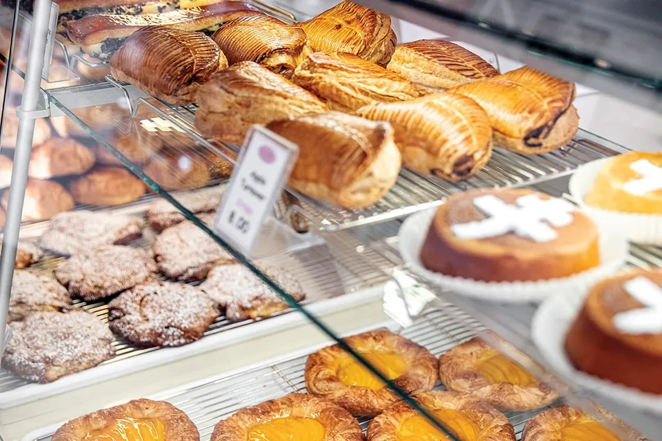 Croissants, pain au chocolat, turnovers, and cakes fill the glass pastry case at Peninsula Pastries.