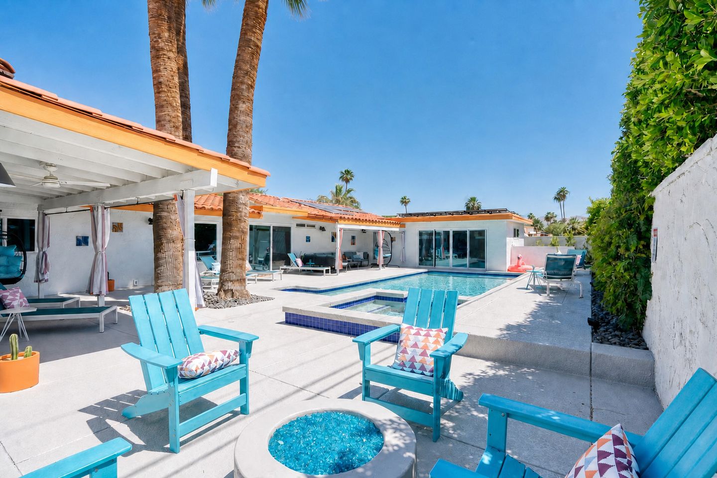 Private pool and raised spa beside a shaded patio with turquoise seating
