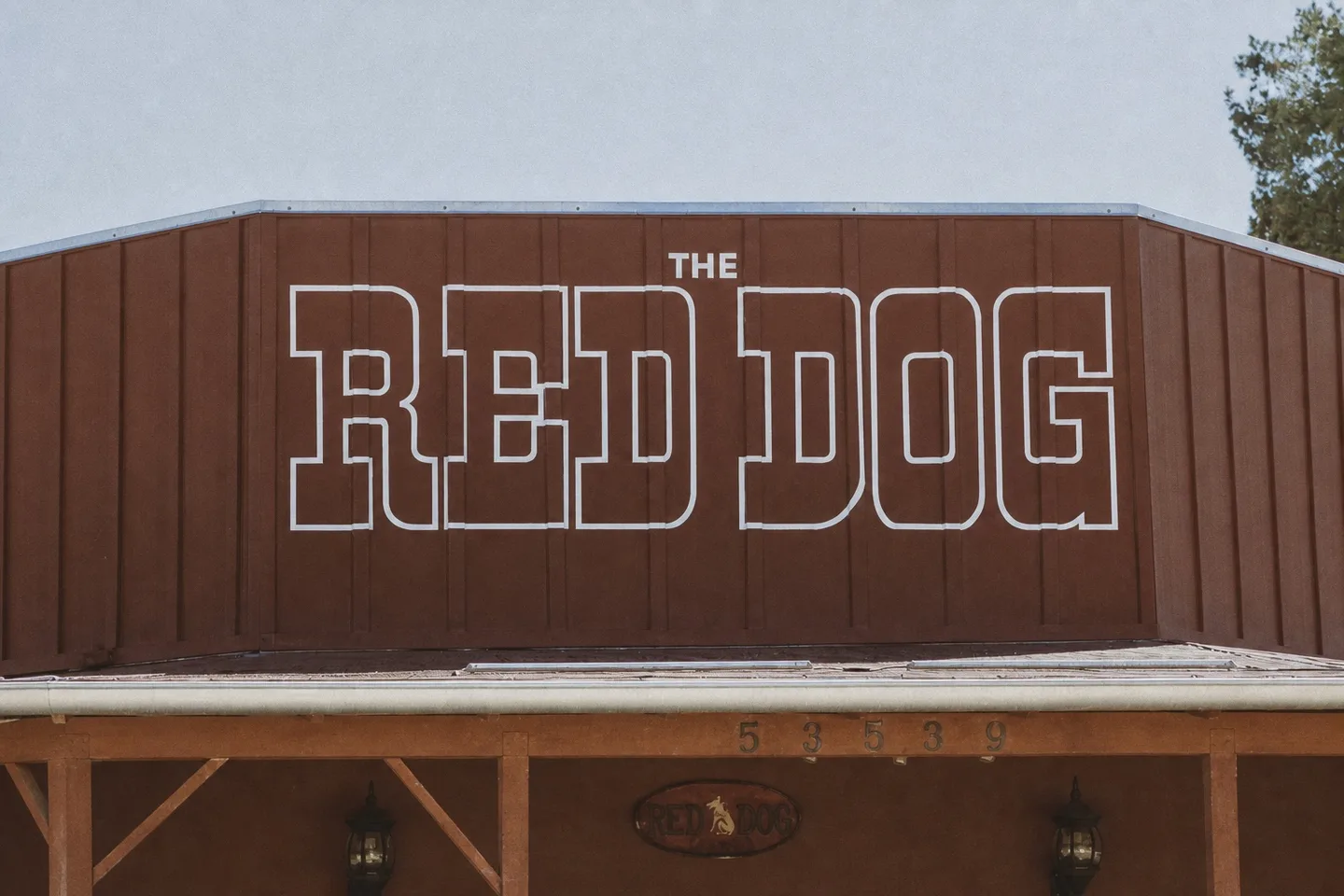 The rust-red Red Dog Saloon facade in Pioneertown with its large white outlined RED DOG sign above the entrance.